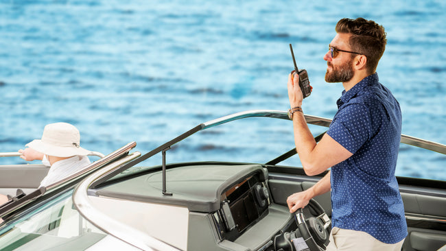 Man on a boat using a Cobra marine radio