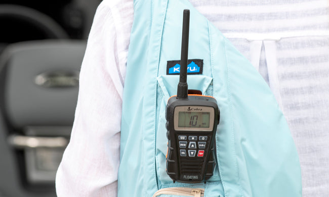 Cobra Blue Bound 150 marine radio clipped to a light blue backpack