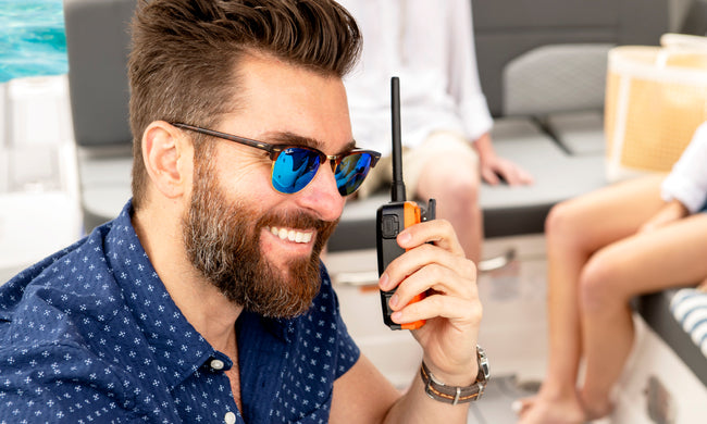 Man on a boat using a Blue Bound 150 marine radio 