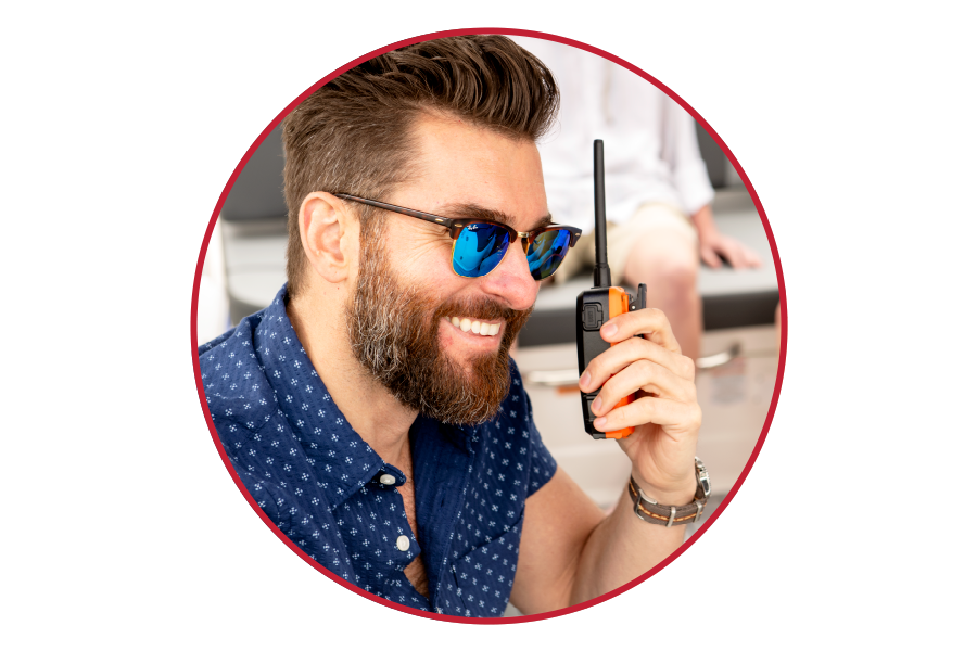 Man with sunglasses holding a Blue Bound 150 marine radio