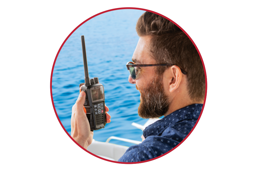 Man on a boat using a handheld radio with water in the background